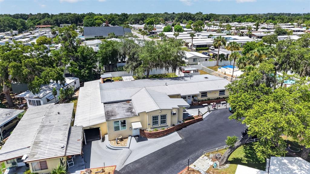 An aerial view shows a single-story building with a metal roof and adjacent parking — 3896 PICCIOLA UNIT 224, FRUITLAND PARK, FL