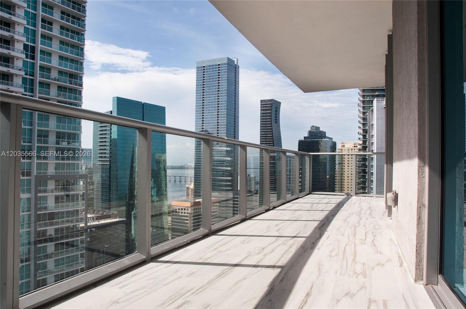 A balcony with glass railings overlooks a city skyline with several high-rise buildings — 1100 S MIAMI AV # 4001, Miami FL 33130, MIAMI, FL
