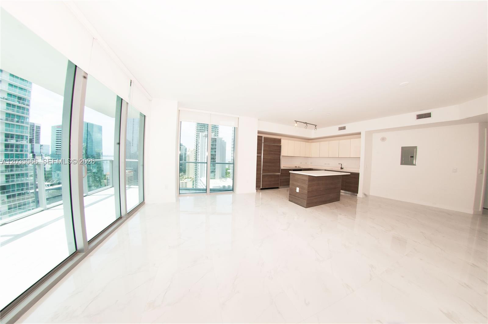 An open-concept living area features white marble floors, a modern kitchen, and floor-to-ceiling windows — 1100 S MIAMI AV # 4001, Miami FL 33130, MIAMI, FL