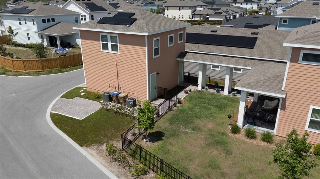 An aerial view shows a two-story house with a fenced yard and a covered walkway — 3008 MIRAGE PLACE, ST CLOUD, FL