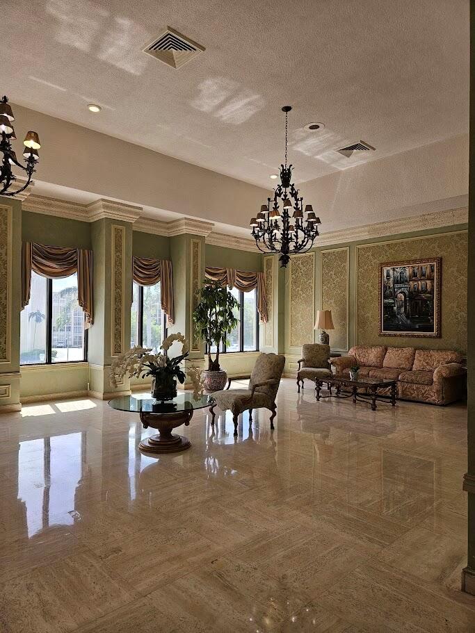 A modern kitchen features white cabinets, stainless steel appliances, and white marble-patterned quartz countertops — 600 Three Islands Boulevard # 620, Hallandale Beach FL 33009, HALLANDALE BEACH, FL
