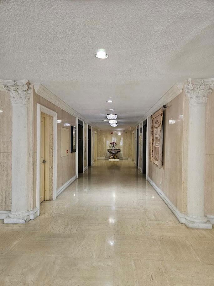 A modern kitchen features white shaker cabinets, stainless steel appliances, and white marble-patterned countertops — 600 Three Islands Boulevard # 620, Hallandale Beach FL 33009, HALLANDALE BEACH, FL