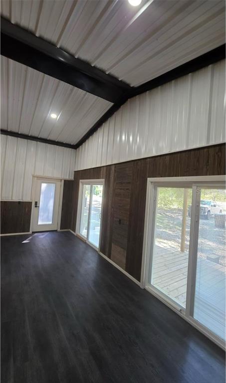An interior view of a room with dark wood paneling, sliding glass doors, and metal ceilings — 401 SW KEMP COURT UNIT Suite B, LAKE CITY, FL