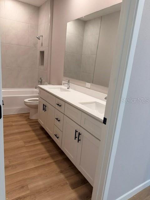 A bathroom features a white double vanity with black hardware, a mirror, and a tub — 5792 SW 117TH LANE ROAD, OCALA, FL