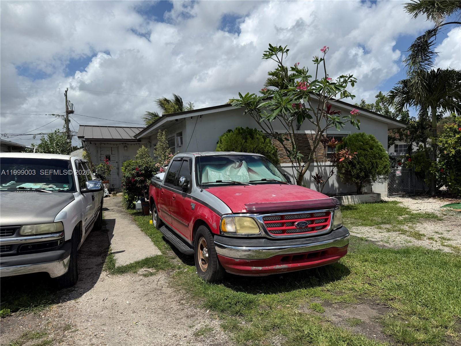 A red and silver Ford pickup truck is parked in front of a single-story house — 9283 SW 39th St, Miami FL 33165, MIAMI, FL