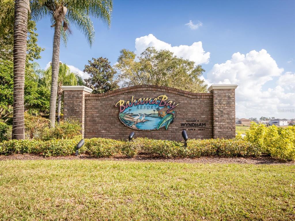 A brick monument sign for Bahama Bay Resort stands in a landscaped grassy area — 713 LUCAYA LOOP UNIT 1301, DAVENPORT, FL