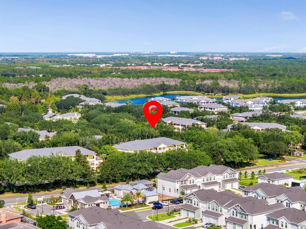 An aerial view shows a residential neighborhood with a red pin marking a building — 713 LUCAYA LOOP UNIT 1301, DAVENPORT, FL