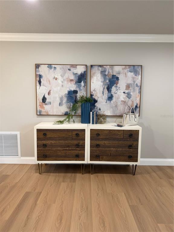 A bathroom features a white vanity, a blue accent wall, and a shower-tub combination — 9608 41ST STREET N UNIT 2, PINELLAS PARK, FL