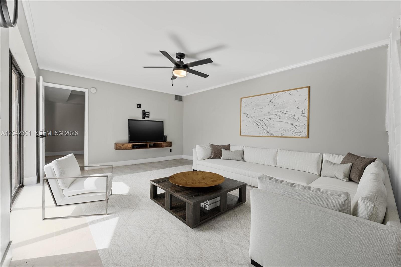 A living room features a white sectional sofa, a dark wood coffee table, and a television — 11867 SW 13th Ct, Davie FL 33325, DAVIE, FL