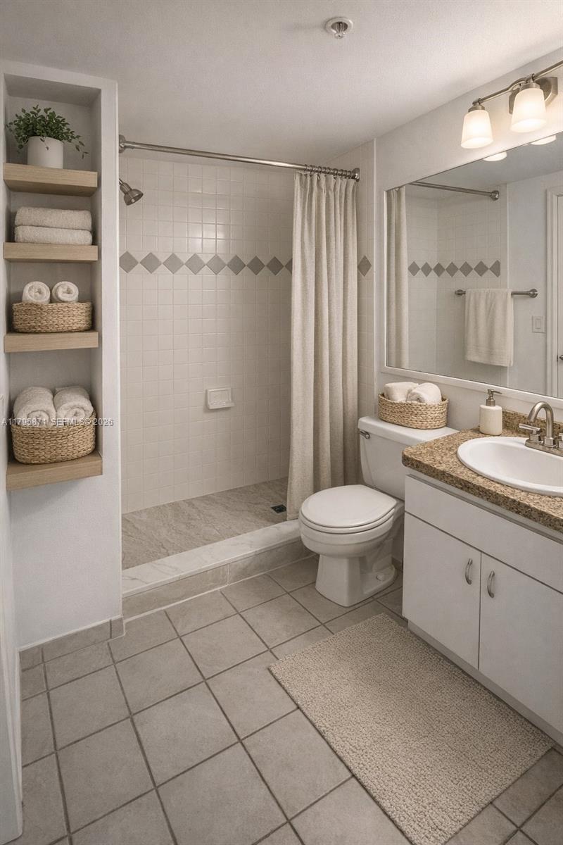A bathroom features a tiled shower, a white vanity, and built-in wooden shelving — 126 SW 17th Rd # 505, Miami FL 33129, MIAMI, FL