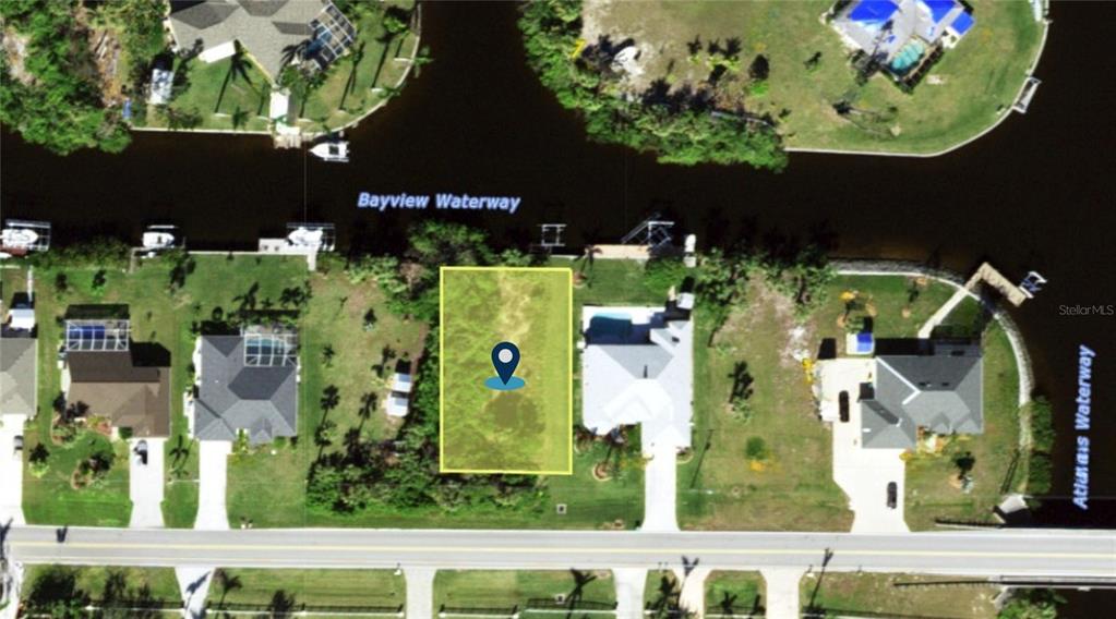 This aerial map shows a vacant waterfront lot highlighted in yellow along a canal — 17542 OHARA DRIVE, PORT CHARLOTTE, FL