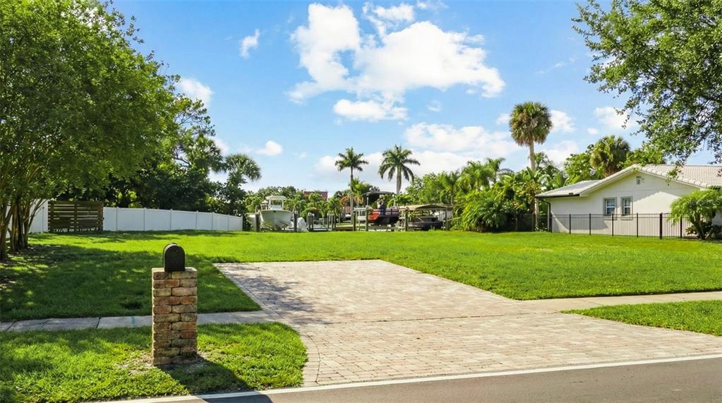 A paved driveway leads to a grassy lot with a brick mailbox and boat slips — 3904 DANA SHORES DRIVE, TAMPA, FL