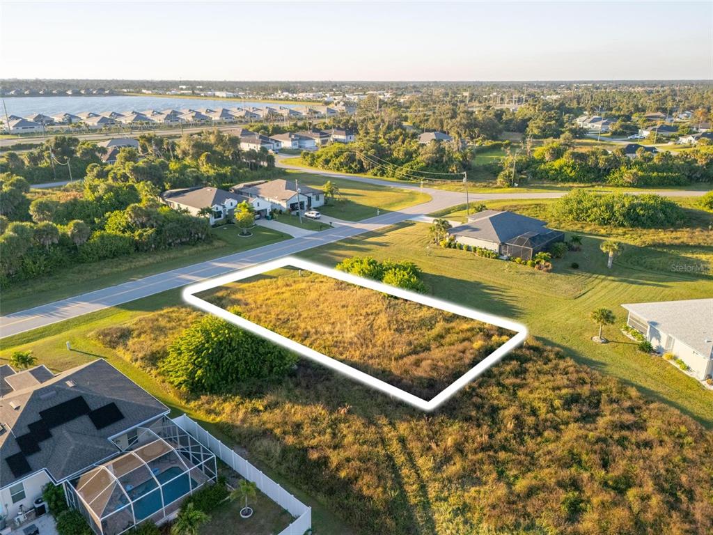 An aerial view shows a rectangular vacant lot outlined in white within a residential neighborhood — 278 INDIAN CREEK DRIVE, ROTONDA WEST, FL