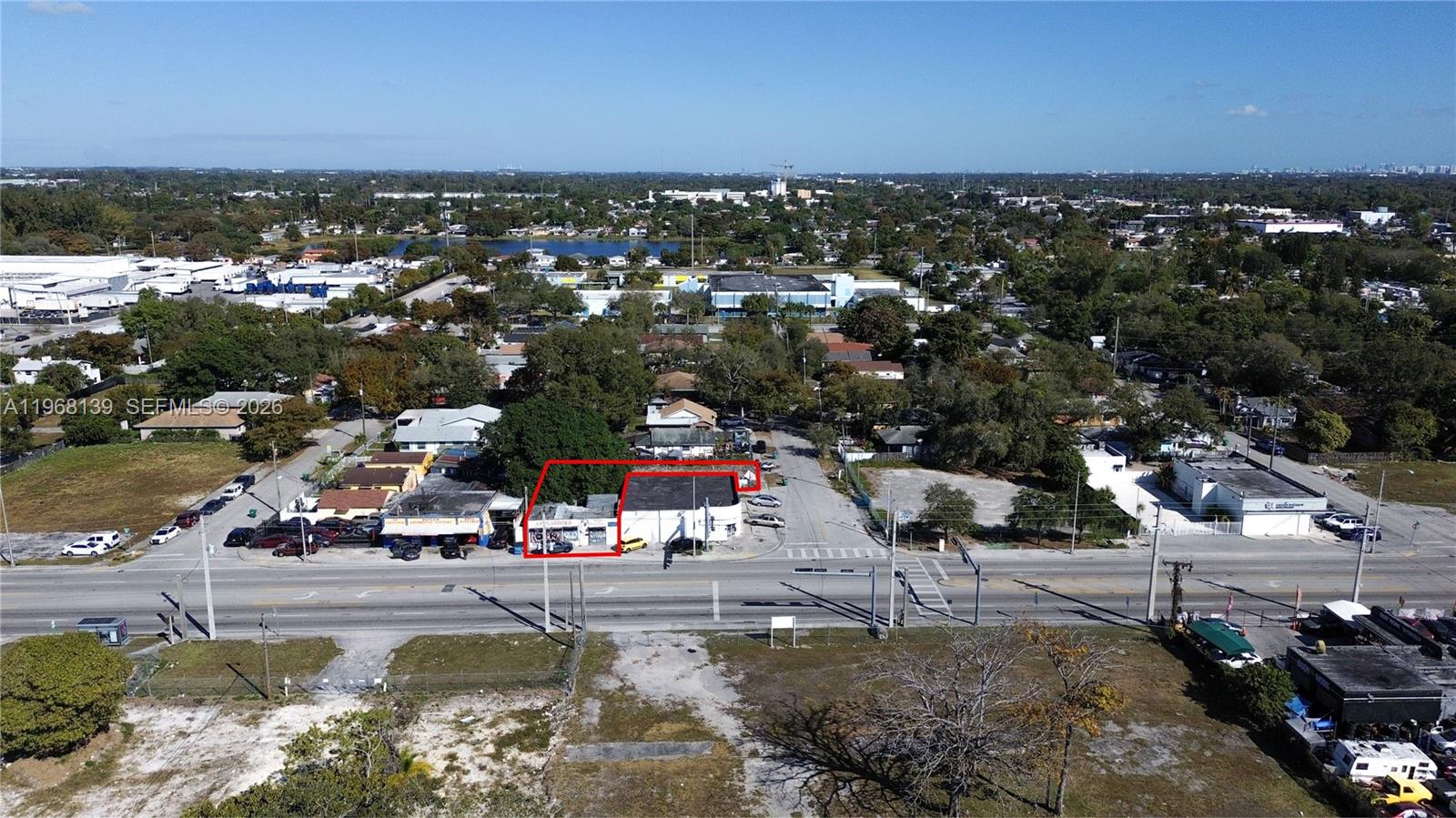 An aerial view shows a commercial property lot outlined in white near a street intersection — 1067 NW 79th St, Miami FL 33150, MIAMI, FL
