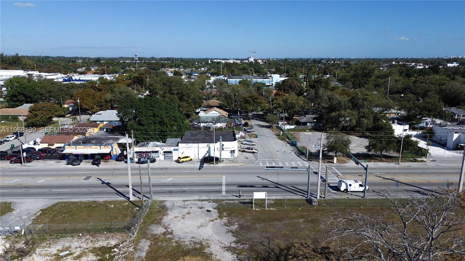 An aerial view shows a commercial building with an adjacent lot outlined in white — 1067 NW 79th St, Miami FL 33150, MIAMI, FL