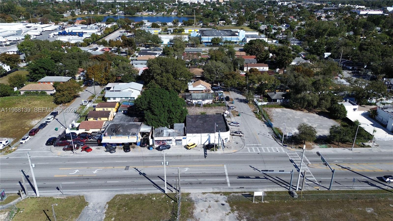 An aerial view shows a commercial building situated along a multi-lane road — 1067 NW 79th St, Miami FL 33150, MIAMI, FL
