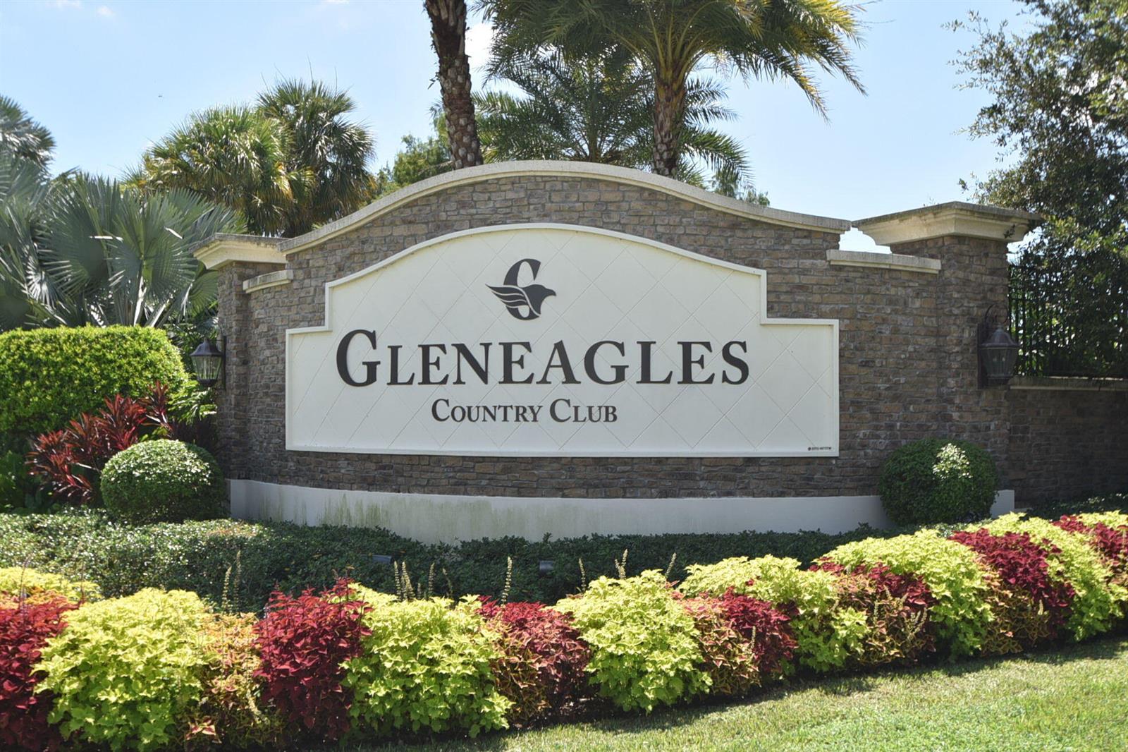 A stone monument sign displays the name Gleneagles Country Club surrounded by lush landscaping — 7563 Glendevon Lane # 1306, Delray Beach FL 33446, DELRAY BEACH, FL