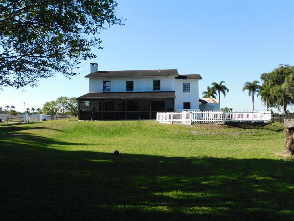 A two-story white house with a dark roof and a screened porch sits on grass — 14201 SW 48th Court, Miramar FL 33027, MIRAMAR, FL