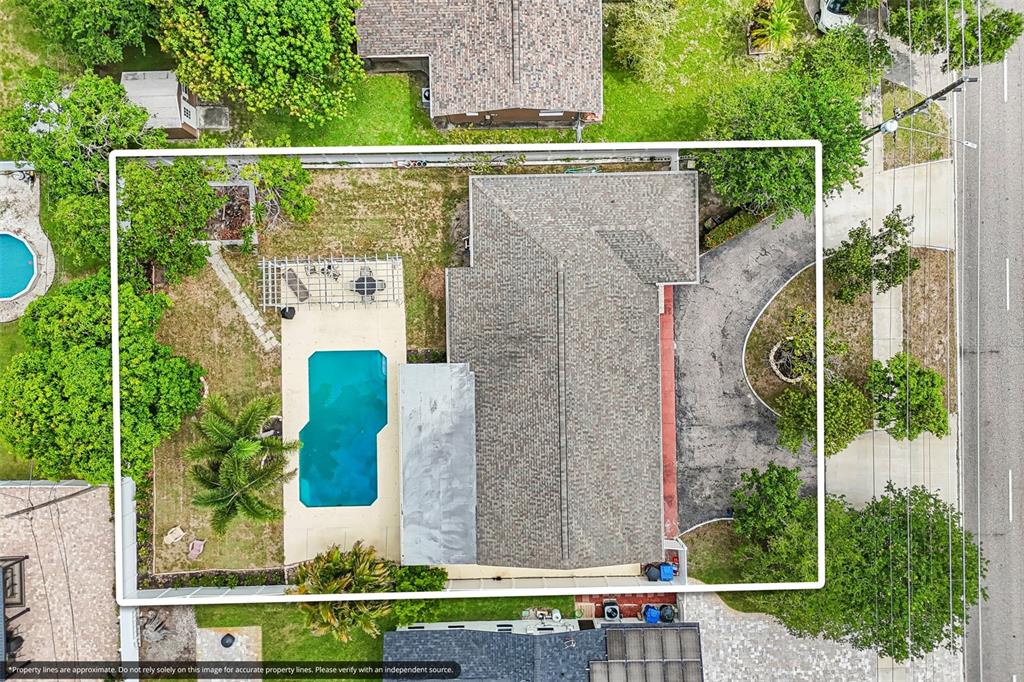 An aerial view of a residential property featuring a house, swimming pool, and driveway — 2709 49TH STREET N, ST PETERSBURG, FL