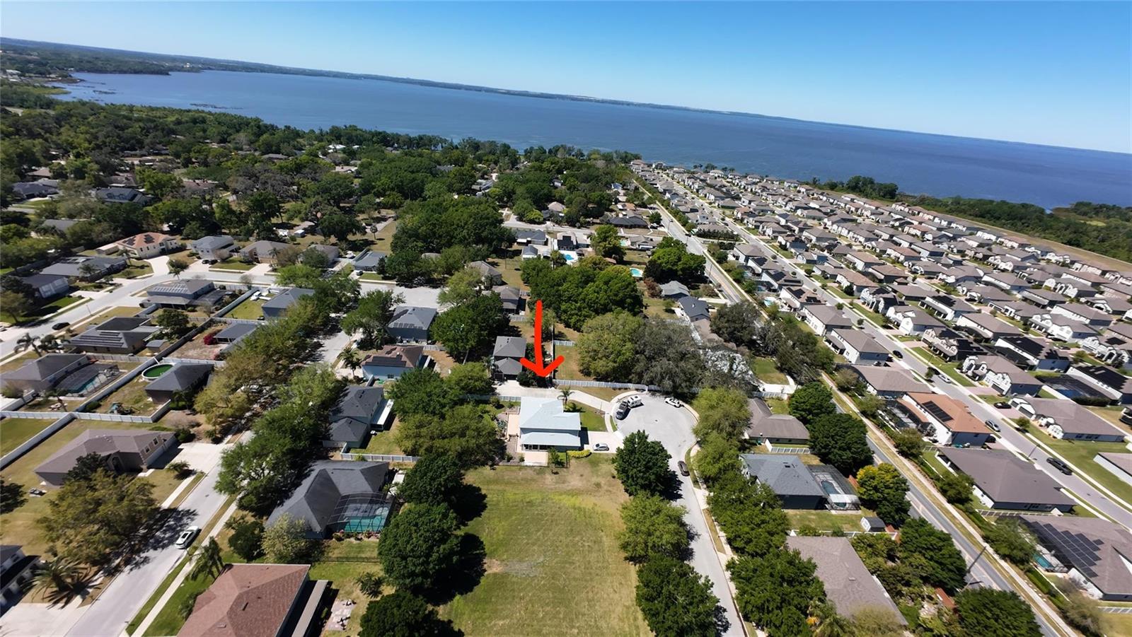 An aerial view shows a residential neighborhood with a house highlighted by a red arrow — 921 Westcliffe Drive, Winter Garden FL 34787, WINTER GARDEN, FL