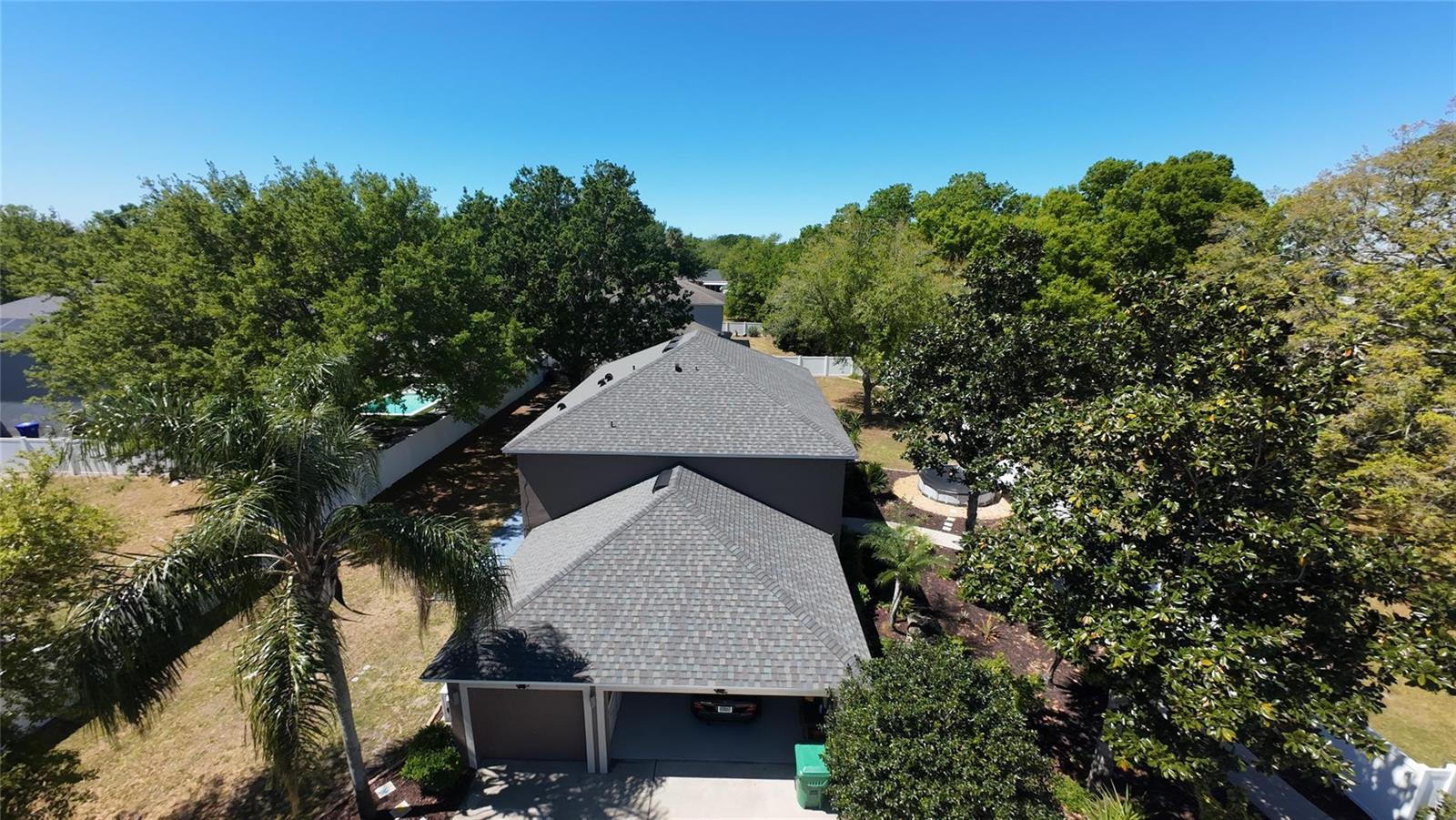 An aerial view of a two-story house with a gray shingled roof and garage — 921 Westcliffe Drive, Winter Garden FL 34787, WINTER GARDEN, FL