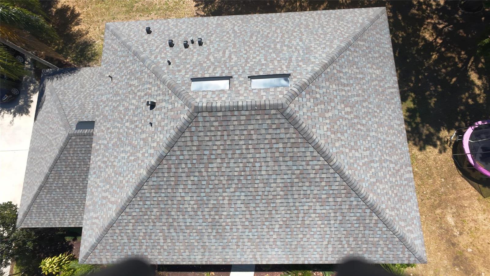 An aerial view shows a shingled hip roof with two skylights and several plumbing vents — 921 Westcliffe Drive, Winter Garden FL 34787, WINTER GARDEN, FL