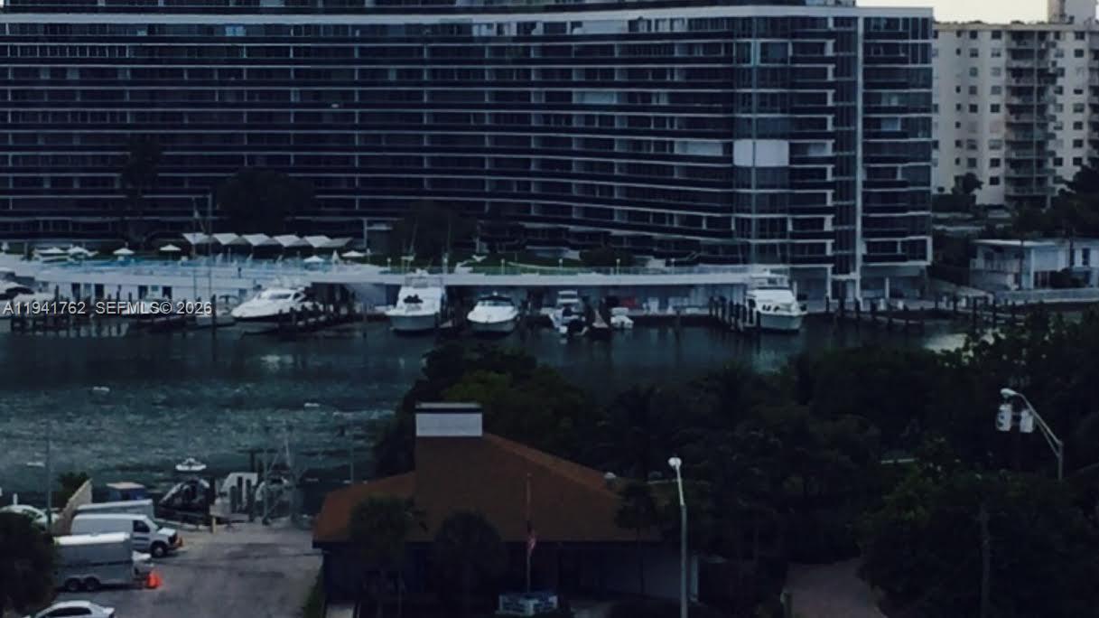 A view of a large residential building with a marina and docked boats — 6855 Abbott Ave # 601, Miami Beach FL 33141, MIAMI BEACH, FL