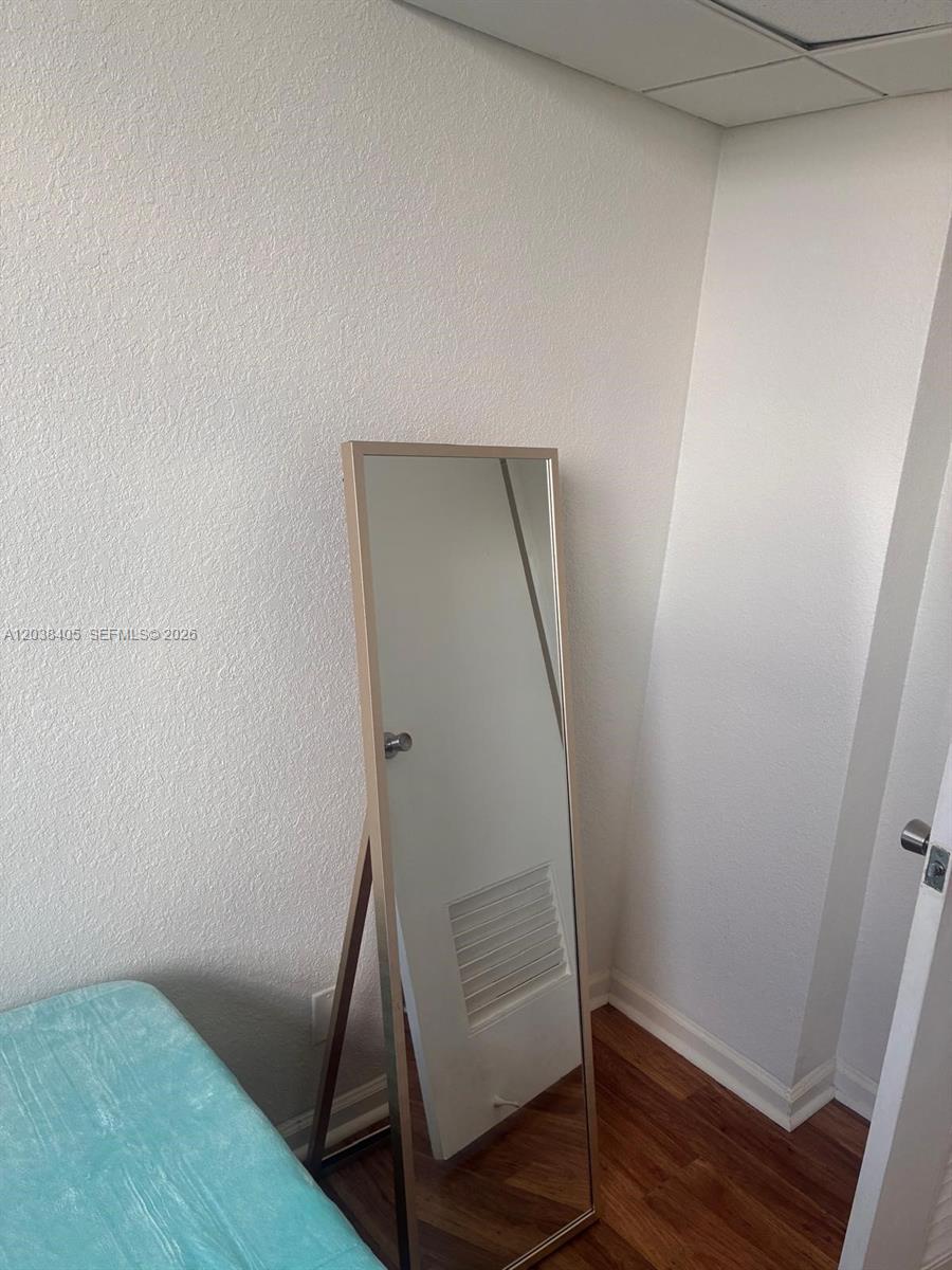 A floor-length mirror stands in the corner of a room with white walls and flooring — 3901 S Ocean Dr # 14Q, Hollywood FL 33019, HOLLYWOOD, FL