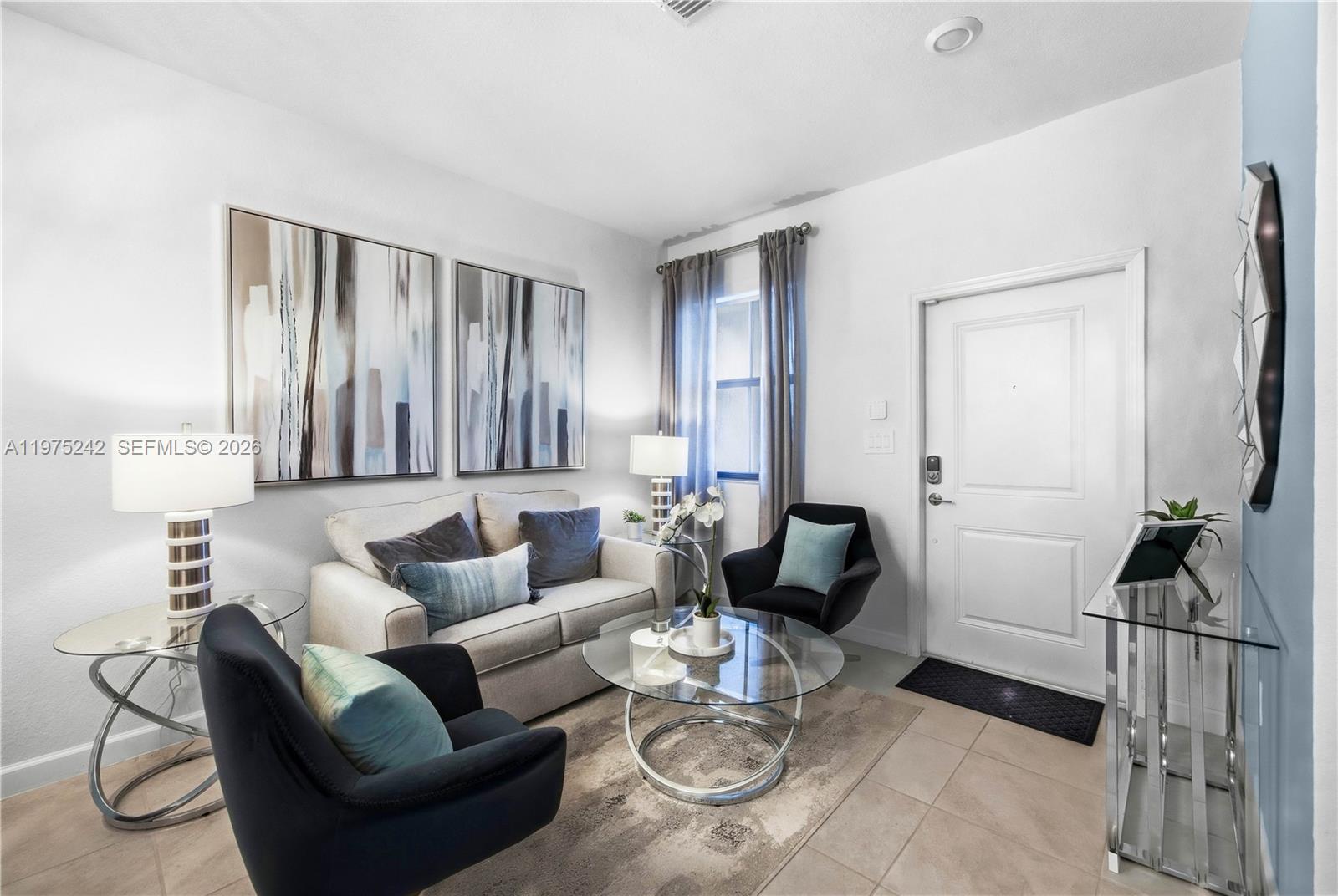 A living room features a sofa, two armchairs, a glass coffee table, and wall art — 13054 SW 233rd Ter, Homestead FL 33032, HOMESTEAD, FL