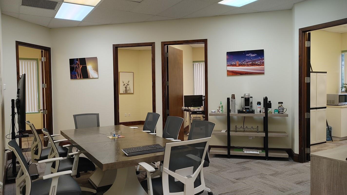 A conference room features a large wooden table, office chairs, and a coffee station — 1565 N Park Drive # 104, Weston FL 33326, WESTON, FL