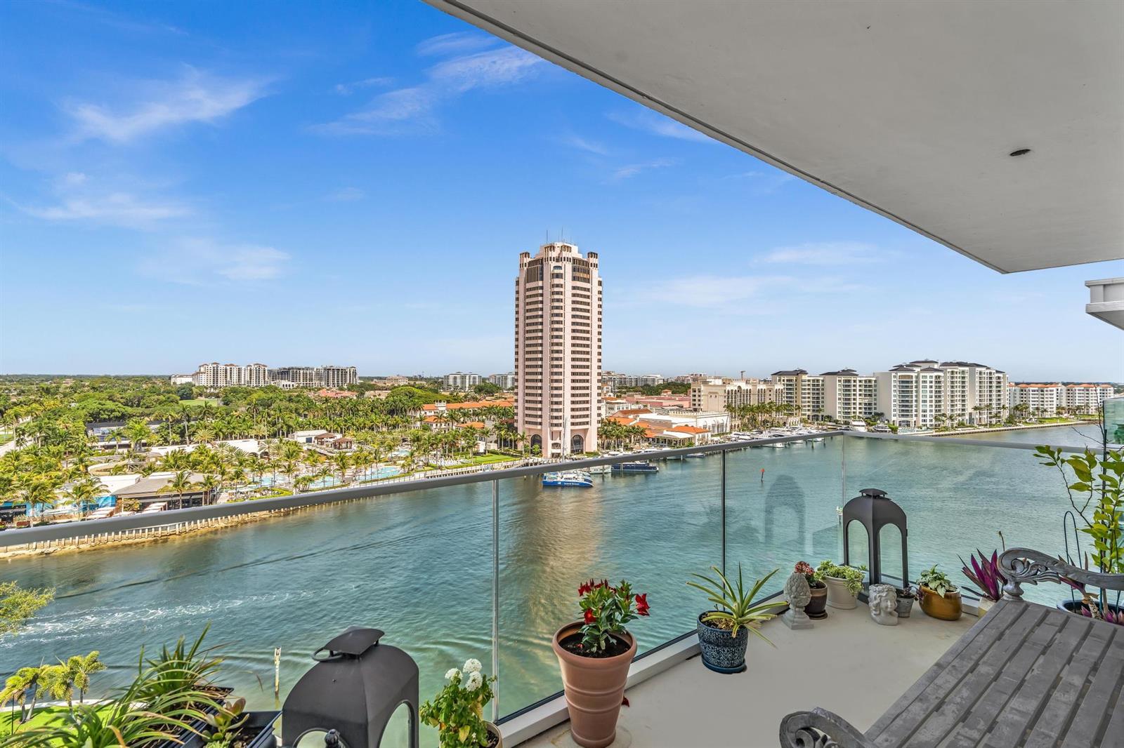 A balcony view overlooking a waterway, a tall building, and surrounding coastal landscape — 701 E Camino Real # 12g, Boca Raton FL 33432, BOCA RATON, FL