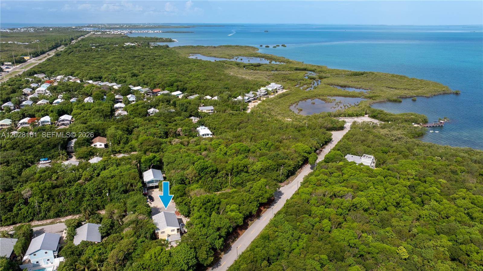 An aerial view shows a house with a blue arrow pointing to its roof — 411 Mahogany Ave, Key Largo FL 33037, KEY LARGO, FL
