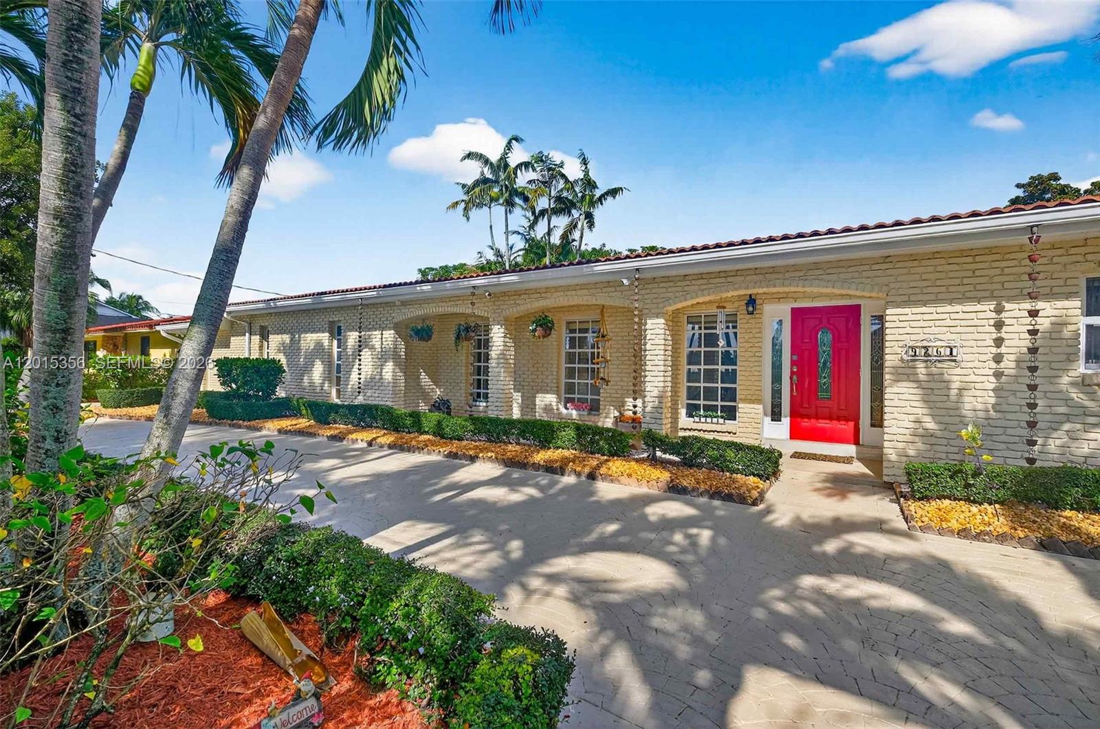 A single-story brick house with a red front door and a paved driveway — 9261 SW 88 st, Miami FL 33176, MIAMI, FL