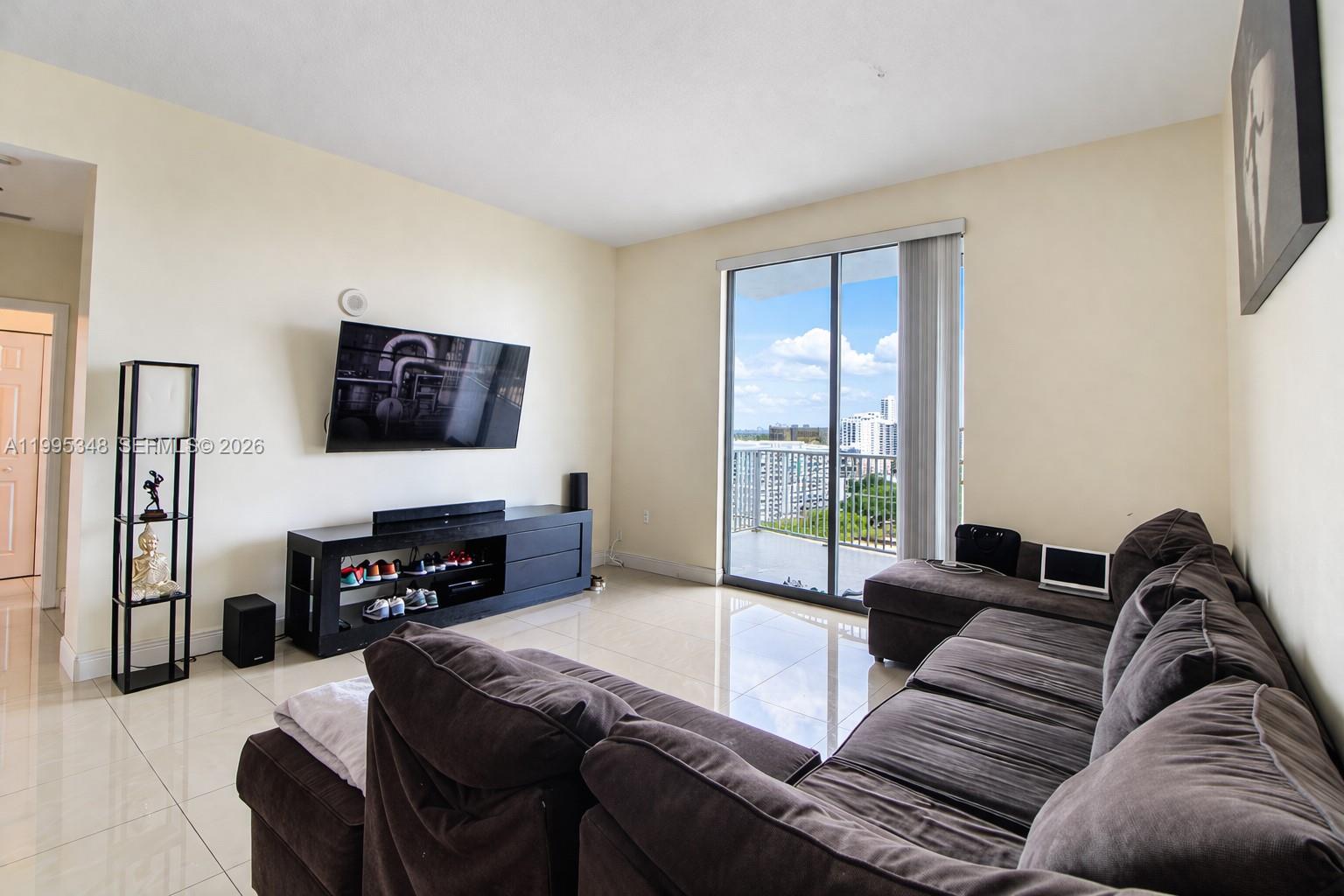 An entryway with beige tile flooring, white walls, a chair rail, and a recessed ceiling — 140 S Dixie Hwy # 1019, Hollywood FL 33020, HOLLYWOOD, FL