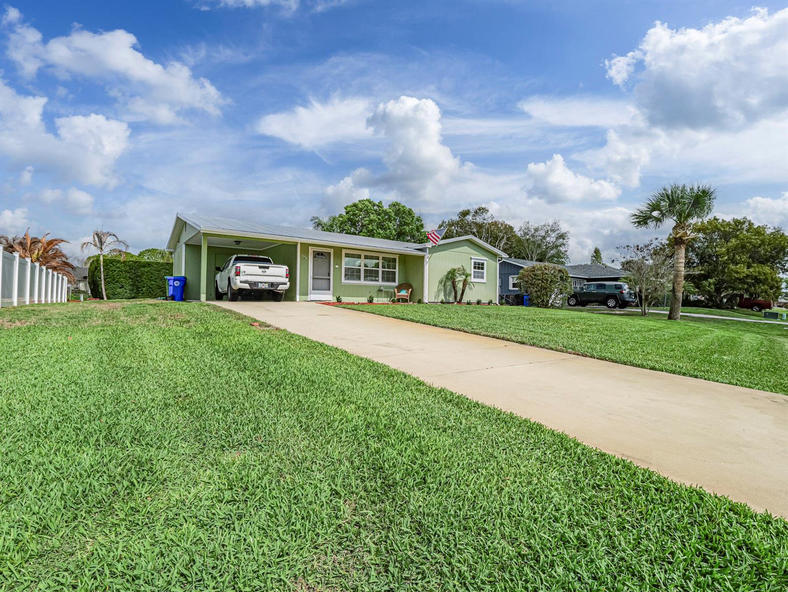 A light green single-story house with a carport and a concrete driveway — 573 Autumn Terrace, Sebastian FL 32958, SEBASTIAN, FL