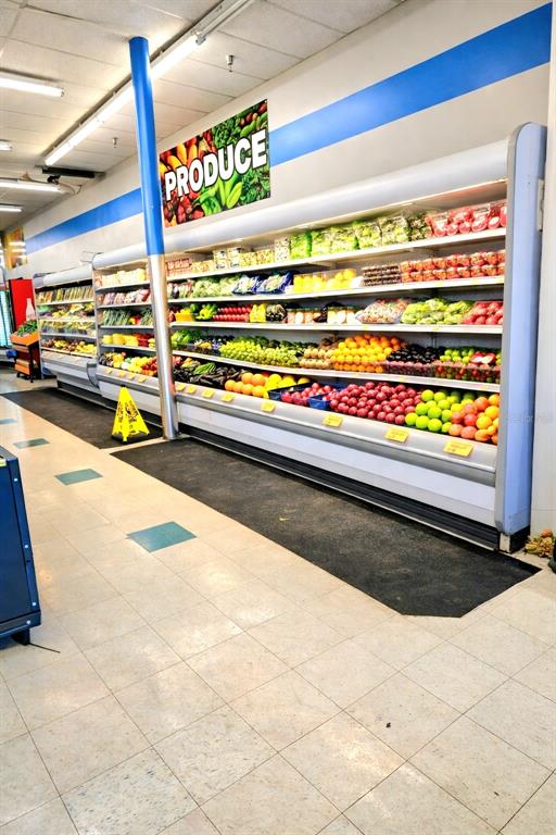 A grocery store produce section features refrigerated display shelves stocked with fresh fruits and vegetables — 4626 S ORANGE BLOSSOM TRAIL, ORLANDO, FL