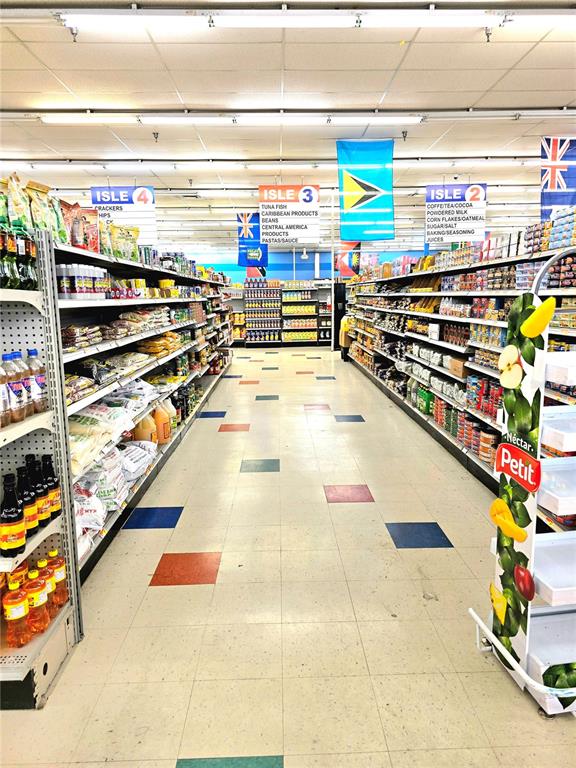 A grocery store aisle features shelves stocked with various food products and colorful floor tiles — 4626 S ORANGE BLOSSOM TRAIL, ORLANDO, FL