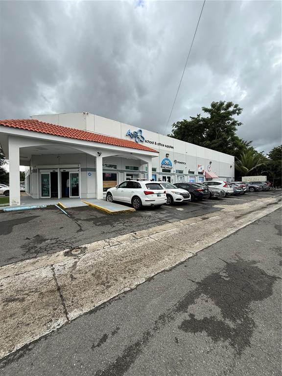 A white commercial building with a red tile roof and a parking lot in front — 177 CALLE ROMERILLO, SAN JUAN, PR