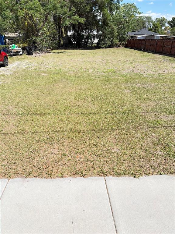A vacant, grassy residential lot is viewed from a concrete sidewalk — 3013 KILGORE STREET, ORLANDO, FL