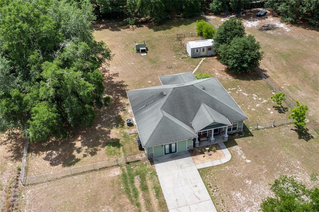 An aerial view shows a single-story house with a green exterior and a large yard — 2750 NW 174TH STREET, TRENTON, FL