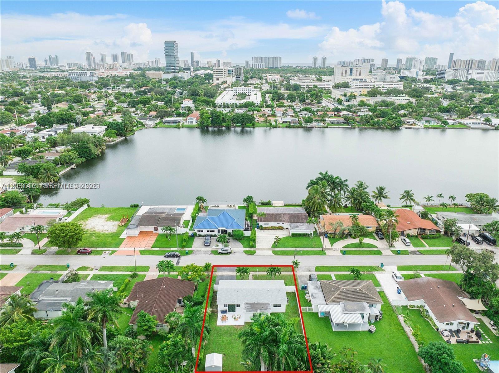 An aerial view shows a single-story house with a fenced backyard and a small shed — 21230 NE 24th Ct # 0, Miami FL 33180, MIAMI, FL