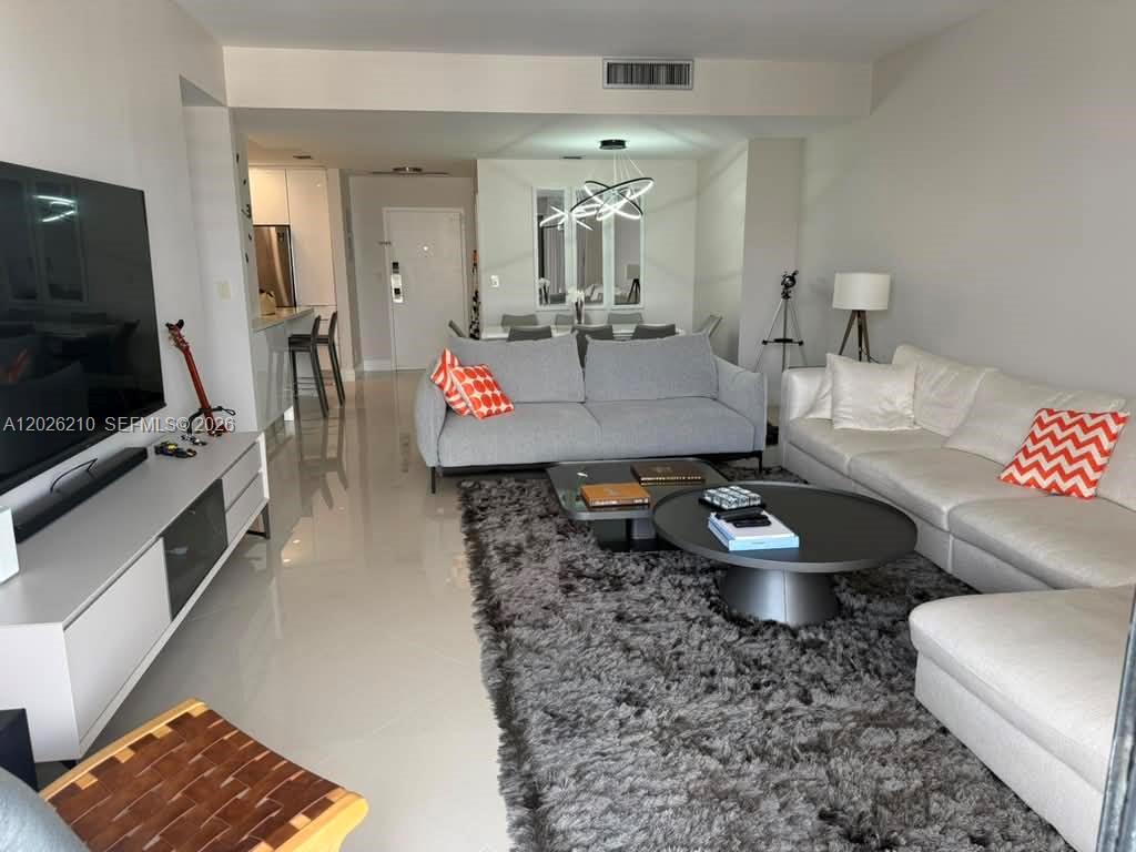 A modern living room features a grey sofa, white sectional, and a large shaggy rug — 2500 Parkview Dr # 2518, Hallandale Beach FL 33009, HALLANDALE BEACH, FL