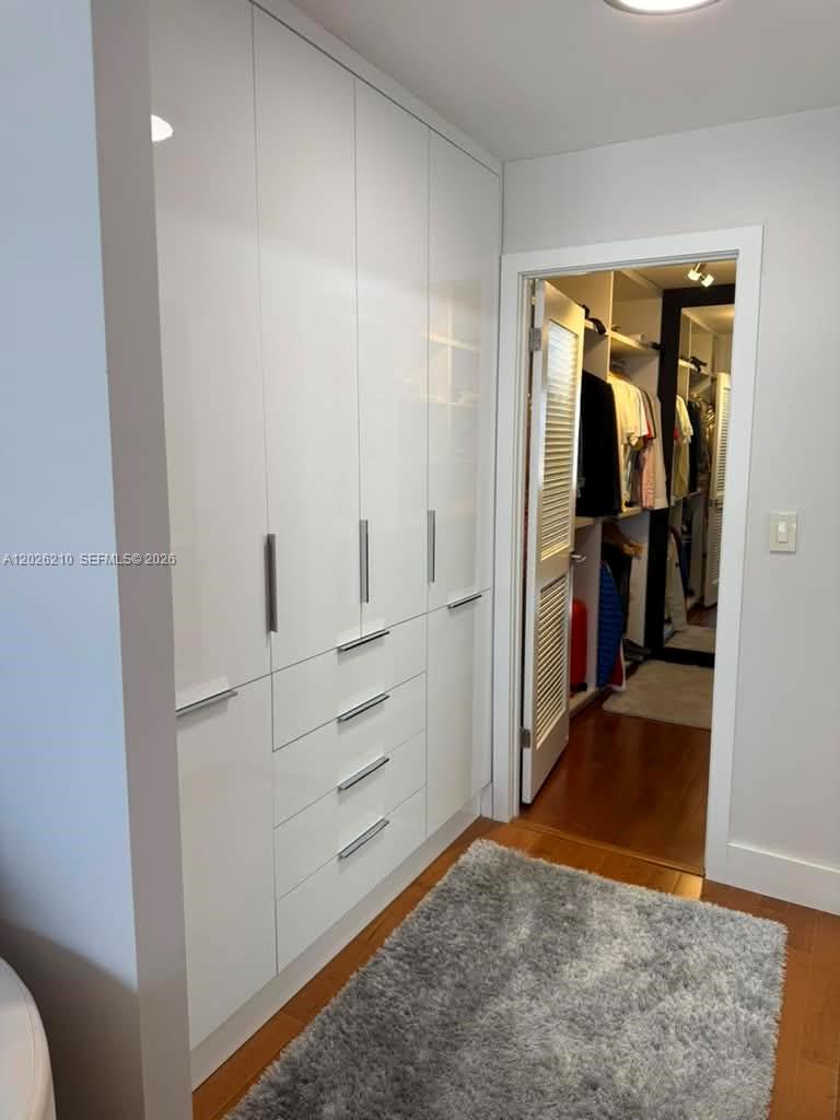 A white floor-to-ceiling wardrobe stands beside a doorway leading into a walk-in closet — 2500 Parkview Dr # 2518, Hallandale Beach FL 33009, HALLANDALE BEACH, FL