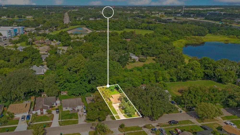An aerial view shows a single-story house with a white outline on a suburban street — 156 LAKE DRIVE, ORLANDO, FL