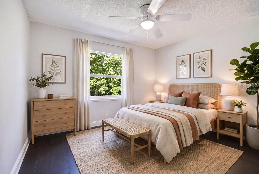 A virtually staged bedroom features a bed, dresser, nightstands, and a ceiling fan — 156 LAKE DRIVE, ORLANDO, FL