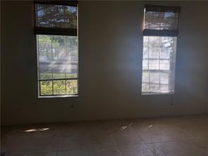 A room with light-colored tile flooring and two windows featuring bamboo shades — 1001 Crystal Way, Delray Beach FL 33444, DELRAY BEACH, FL