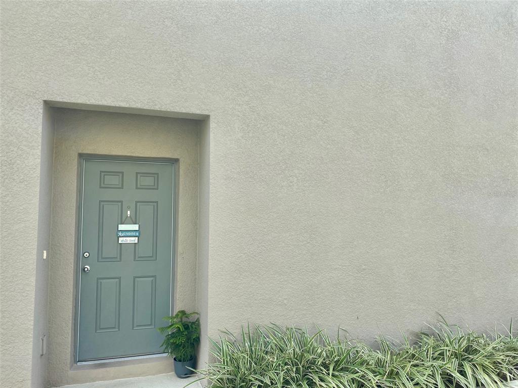 An open living area features tile flooring, a ceiling fan, and sliding glass patio doors — 9035 CARLOTTA WAY, KISSIMMEE, FL
