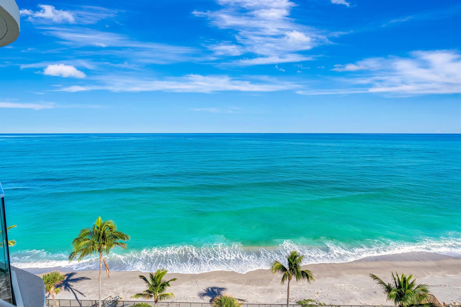 An elevated view of a sandy beach with palm trees and turquoise ocean water — 100 S Beach Road, Jupiter FL 33469, JUPITER, FL