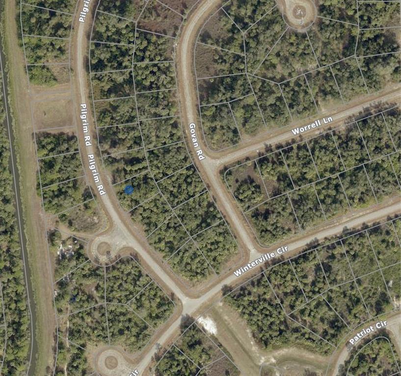 This is an aerial map view of a residential lot located at a road intersection — PILGRIM ROAD, NORTH PORT, FL