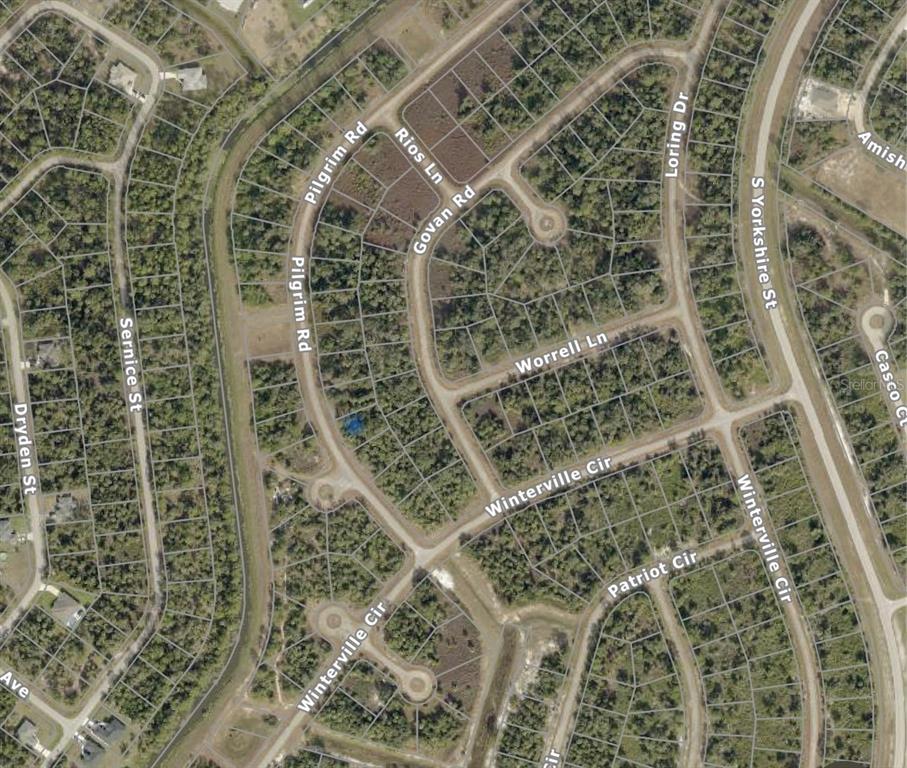 This is an aerial map view of a residential neighborhood with undeveloped wooded lots — PILGRIM ROAD, NORTH PORT, FL